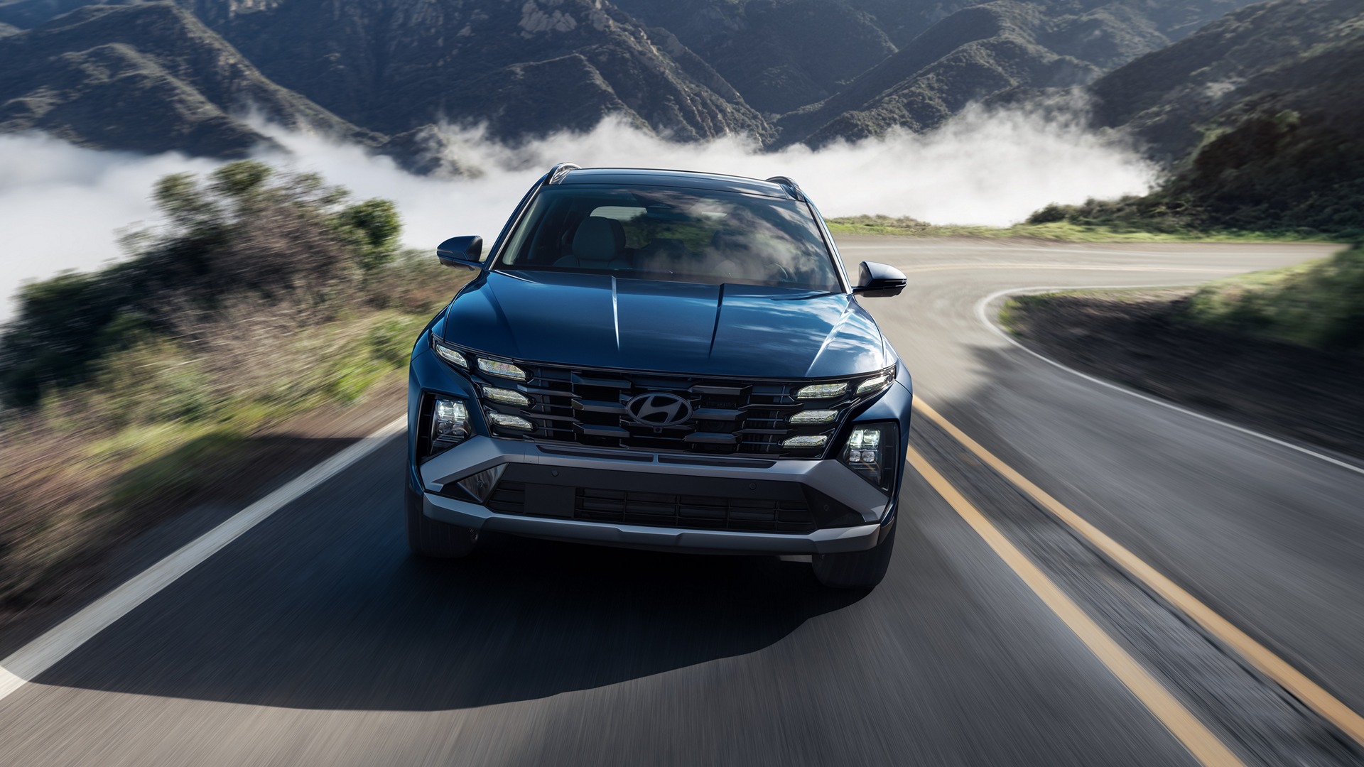 2026 Hyundai Tucson front view on a mountain road (Hyundai press image)