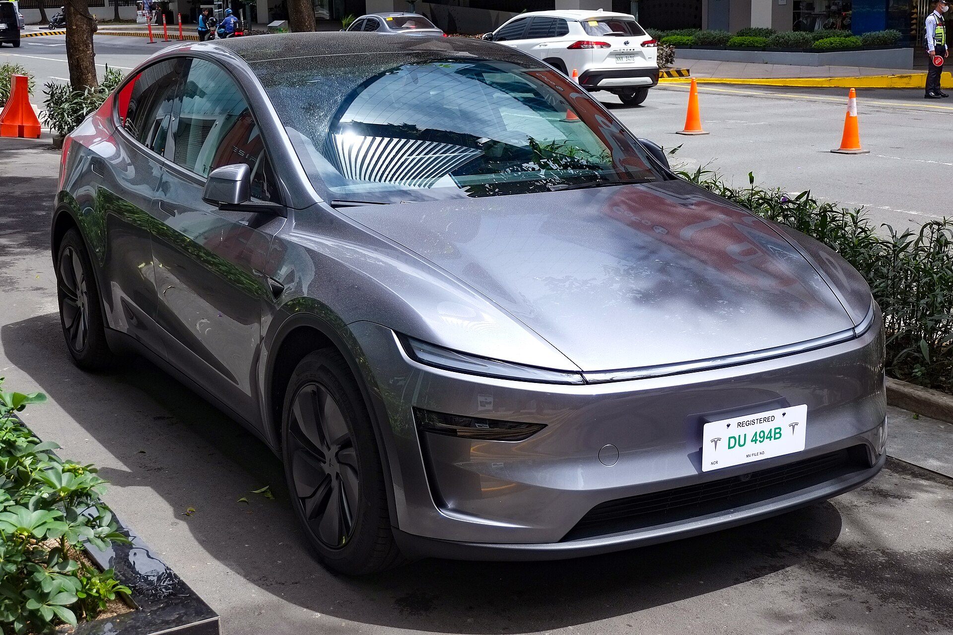 2026 Tesla Model Y RWD Quicksilver front view, base trim in Tesla Model Y vs Hyundai Ioniq 5 2026 comparison