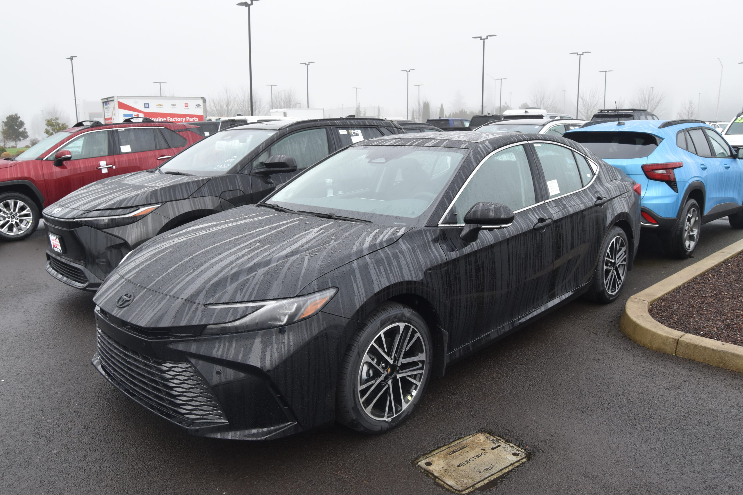 2025 Toyota Camry HEV in pearl white photographed in three-quarter view