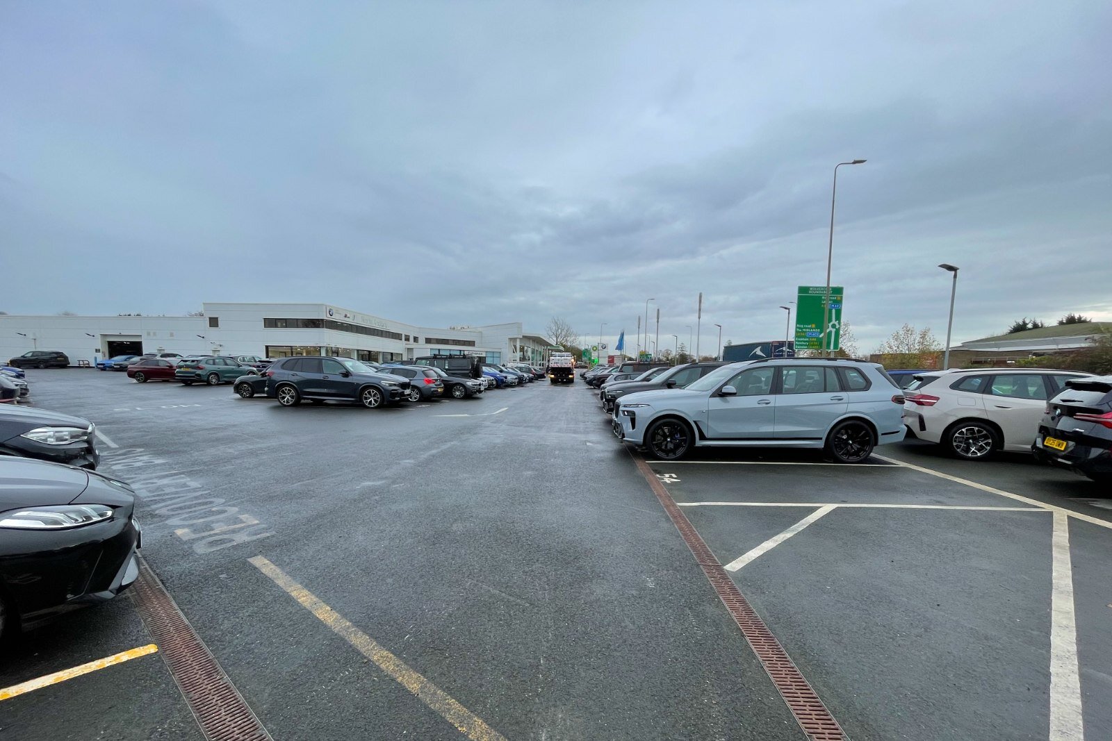 UK dealership car park with new vehicles, illustrating the scale of finance agreements eligible for FCA redress