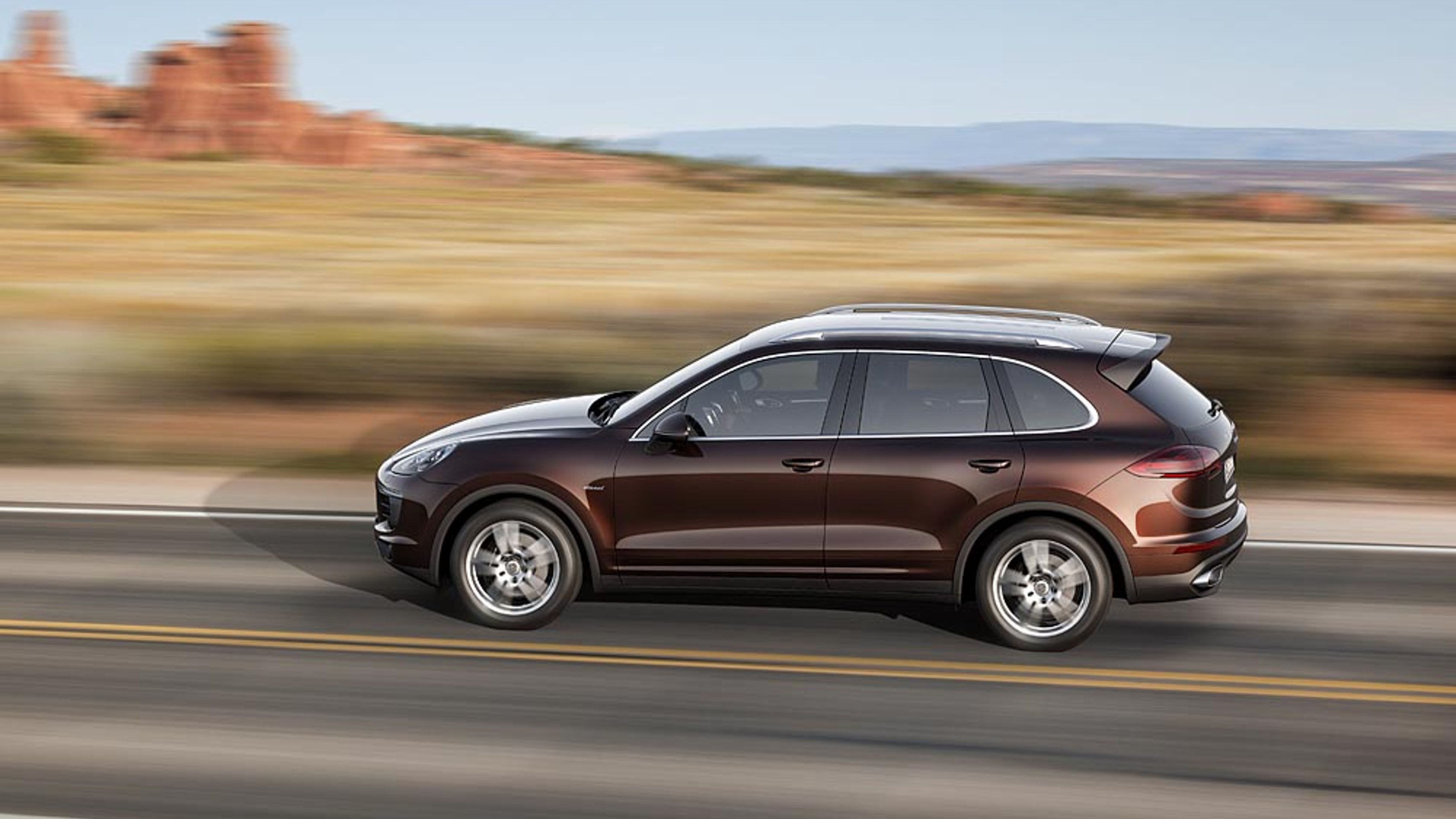 Side profile of a 958-generation Porsche Cayenne on a desert road