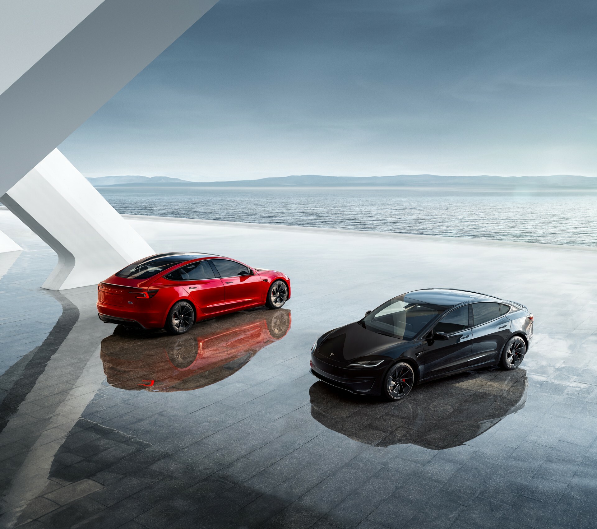 Tesla Model 3 used in red and black, rear and front views by the coast
