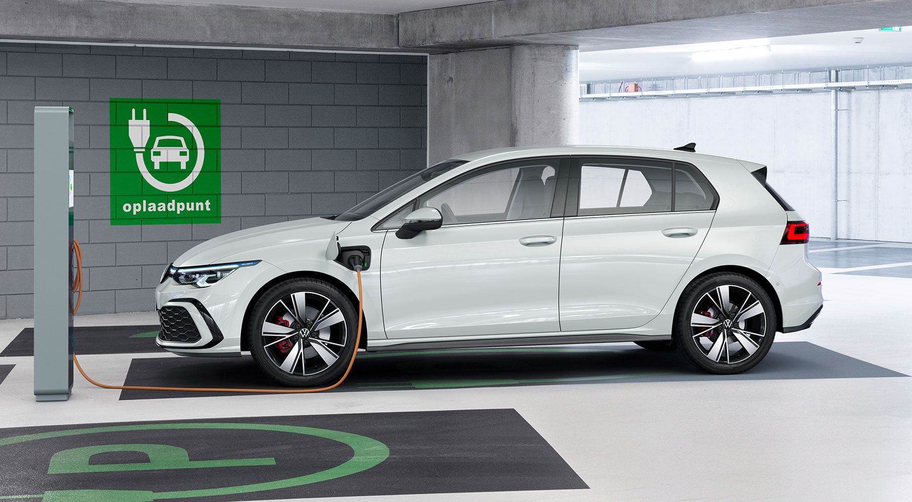 VW Golf Mk8 approved used GTE plug-in hybrid parked beside a charging point