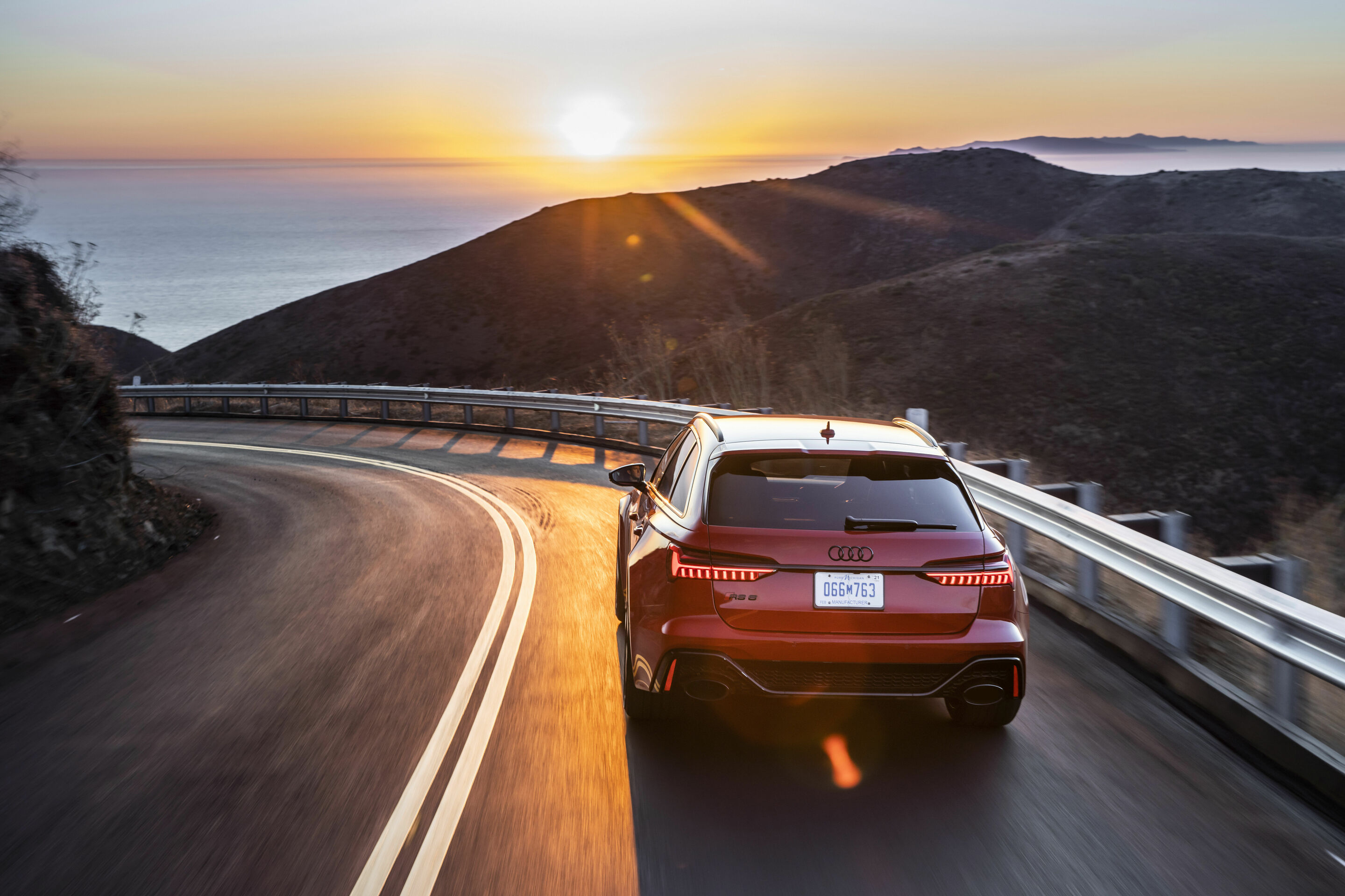 Audi RS6 C8 used Avant driving rear view at sunset