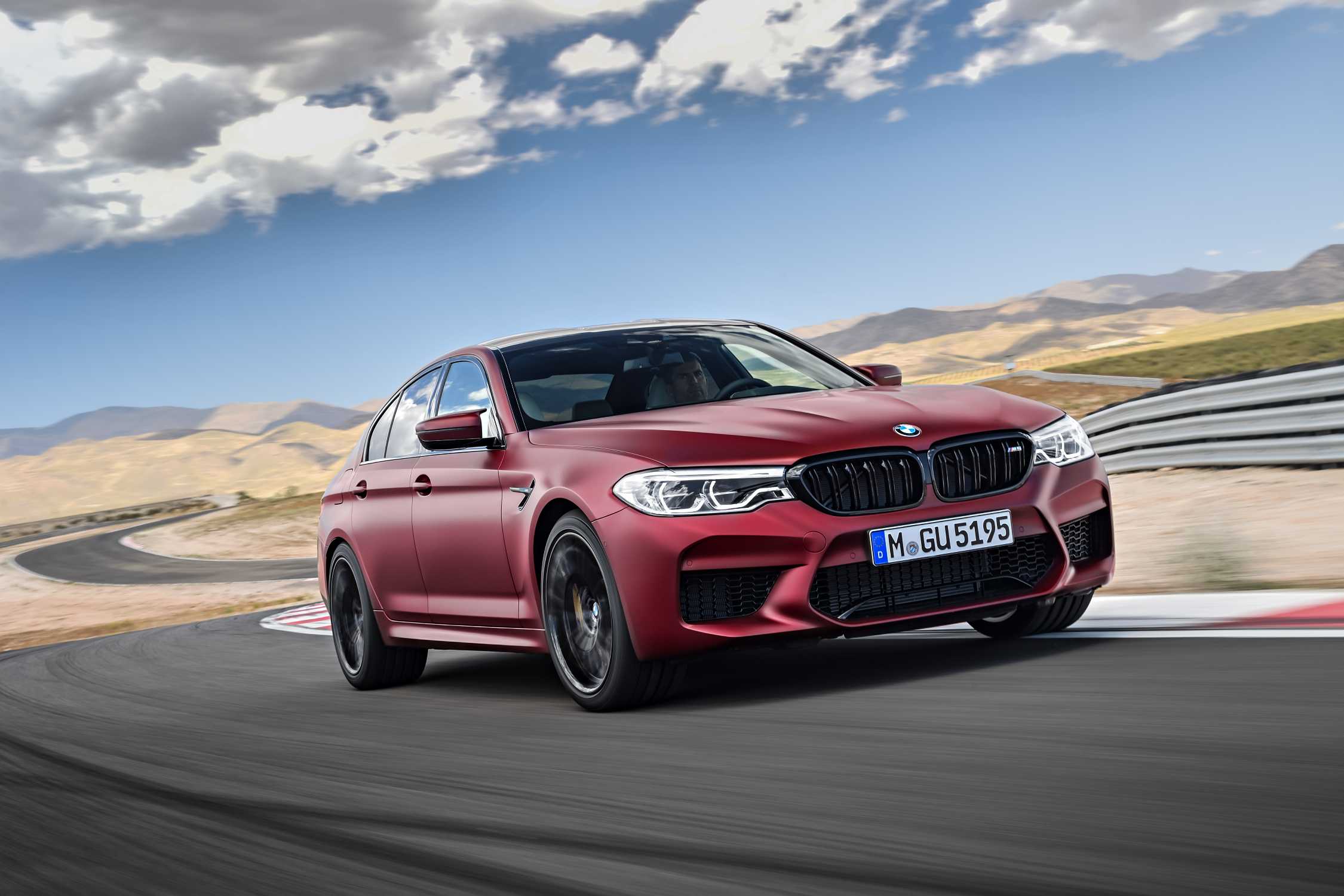 BMW M5 F90 First Edition in Frozen Dark Red on a circuit