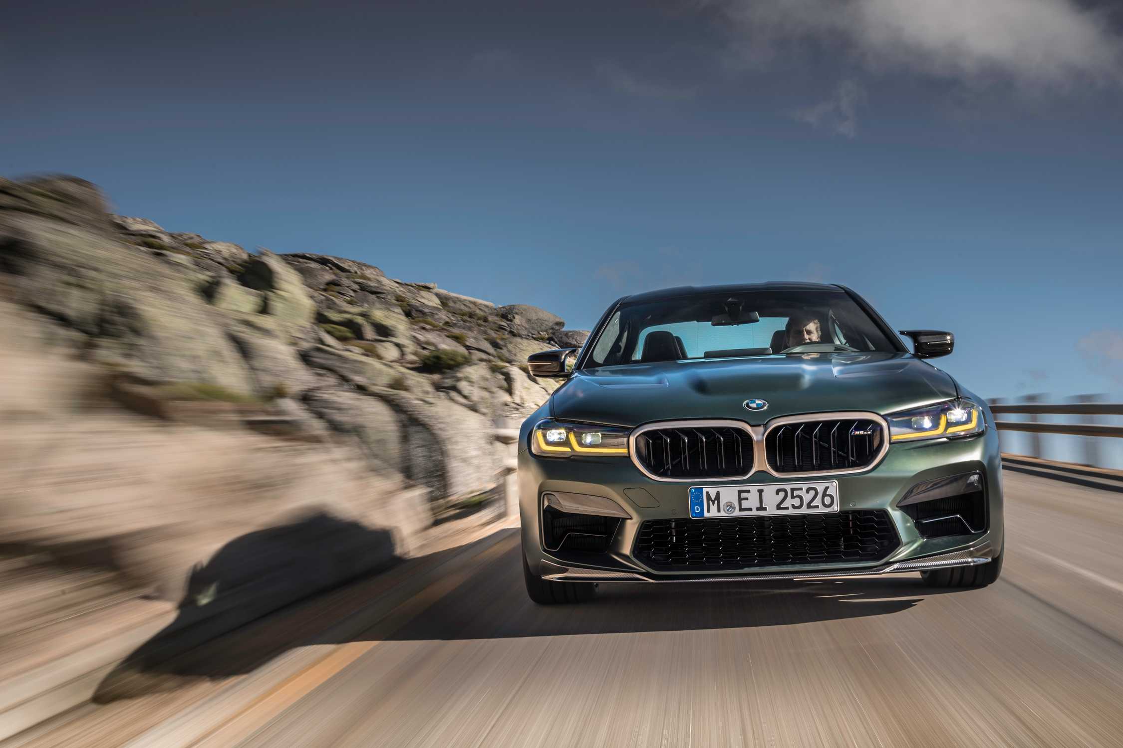BMW M5 CS F90 driving on a mountain road, front view
