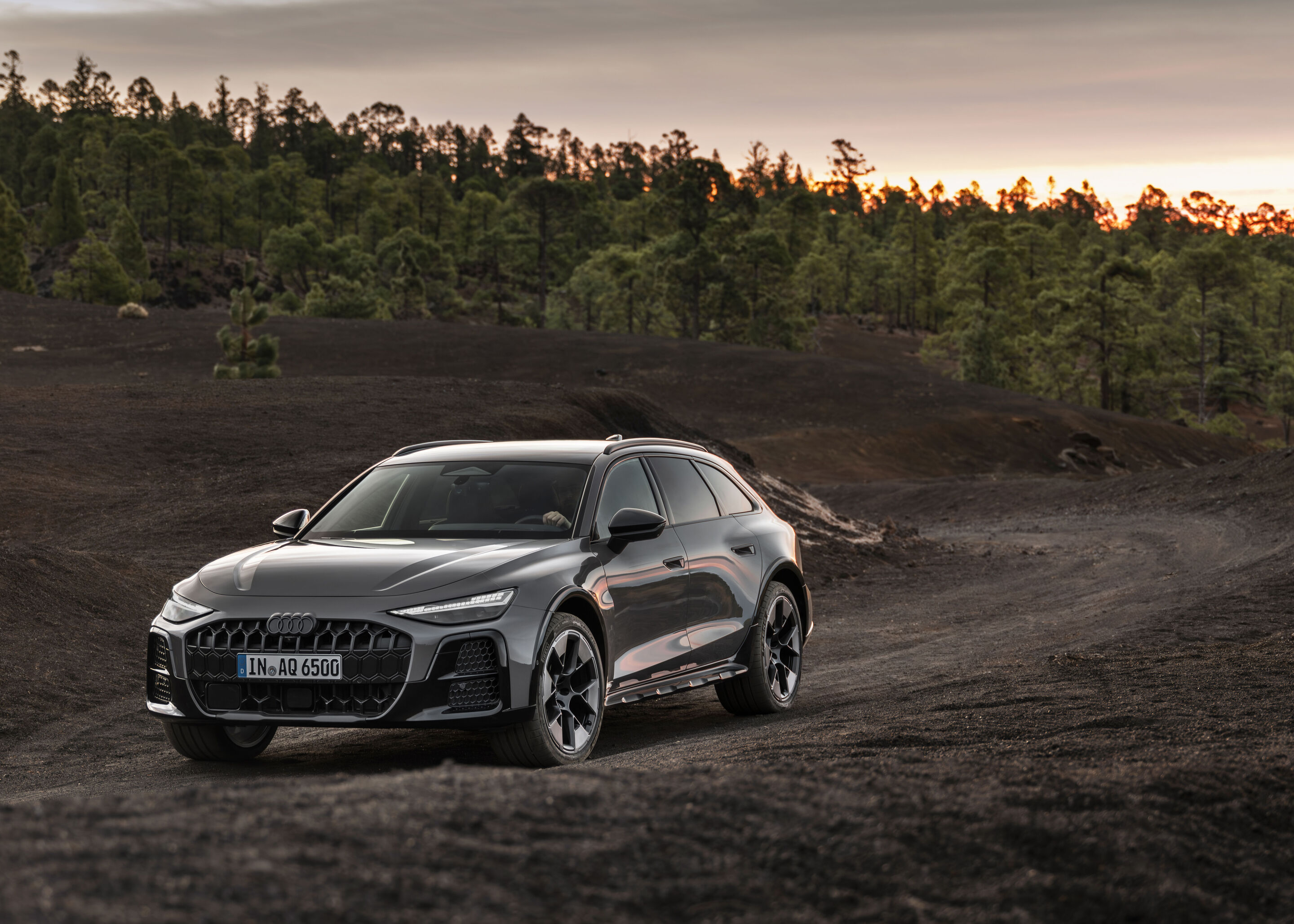 Audi A6 Allroad 2026 on a gravel forest track showing its raised ride height