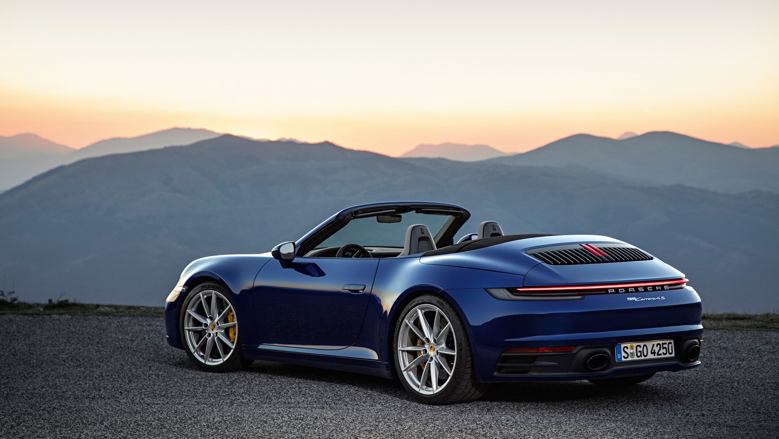 Porsche 911 992 Carrera 4S Cabriolet used buyer's guide hero in blue at sunset