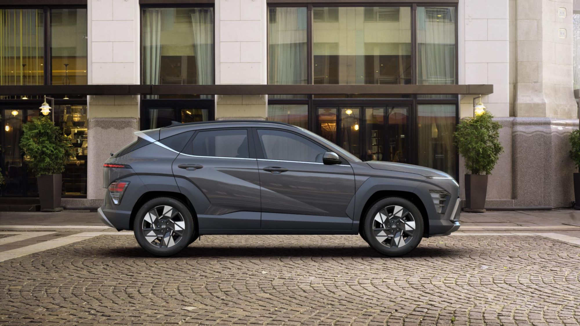 Hyundai Kona Hybrid side profile on a cobblestone street, PCP deals decoded