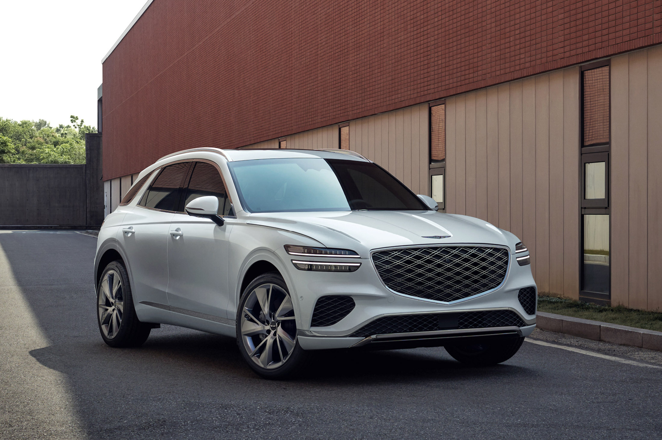 White Genesis GV70 used petrol SUV parked, three-quarter front view
