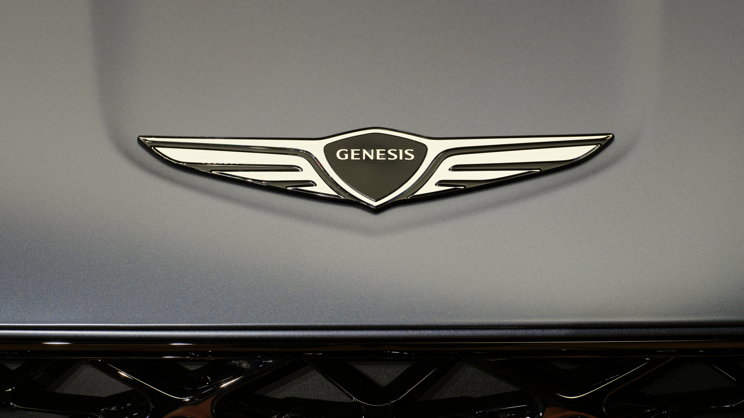 Genesis GV70 used wing badge close-up symbolising the brand five-year care plan