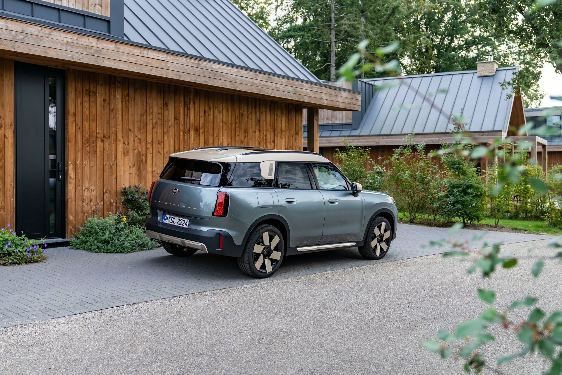 Mini Countryman C rear quarter in a garden setting, the petrol model we price up on PCP