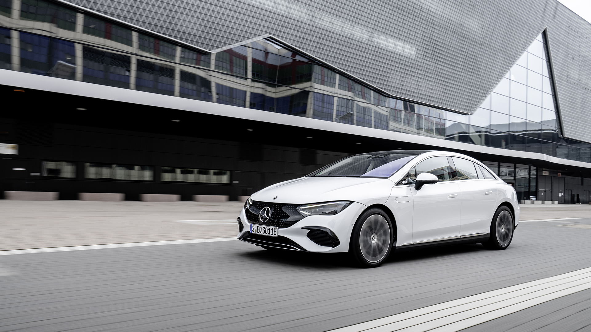 White Mercedes EQE saloon in motion, the aerodynamic long-range executive saloon
