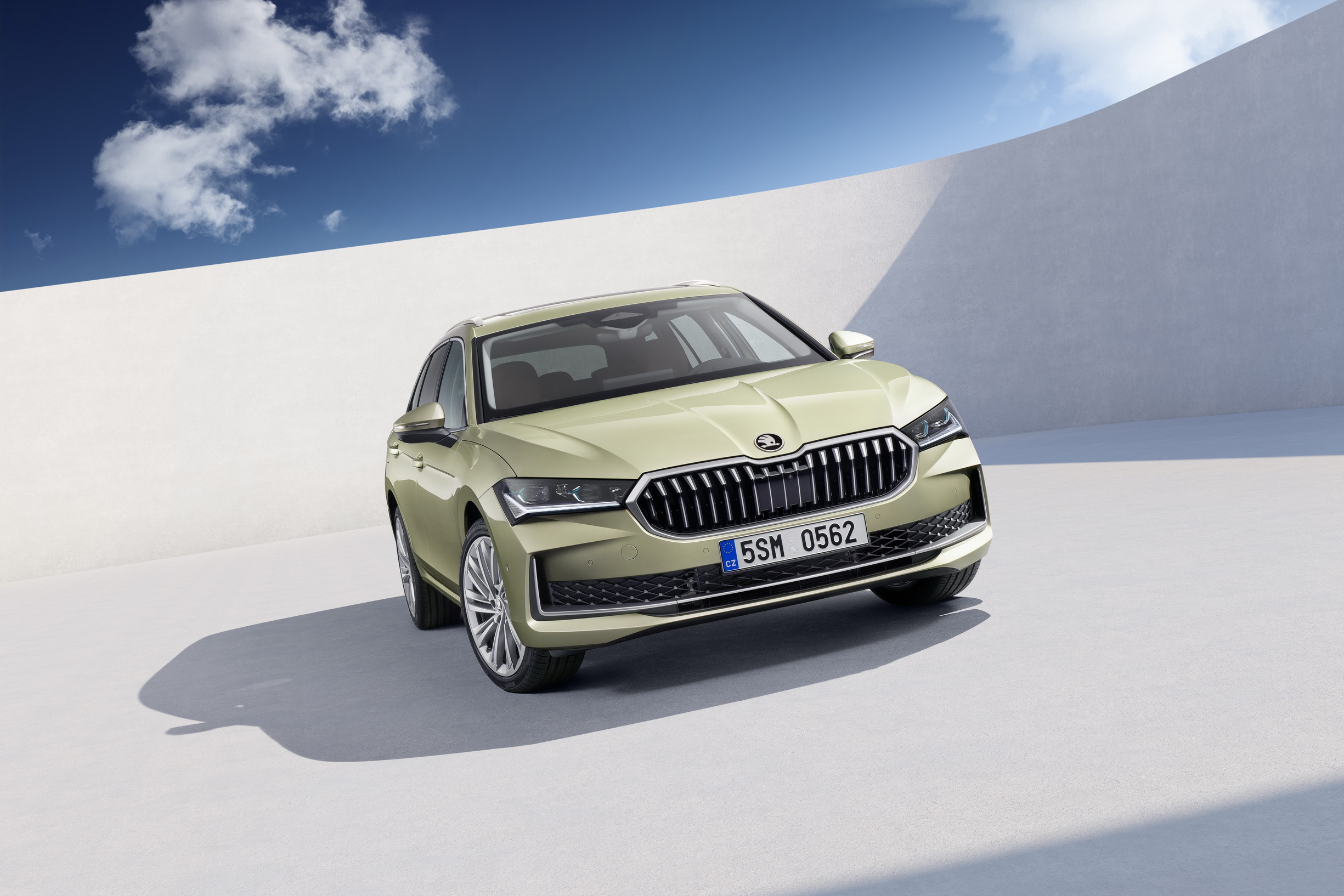Skoda Superb Estate front three-quarter in pale green, new versus one-year-old price gap