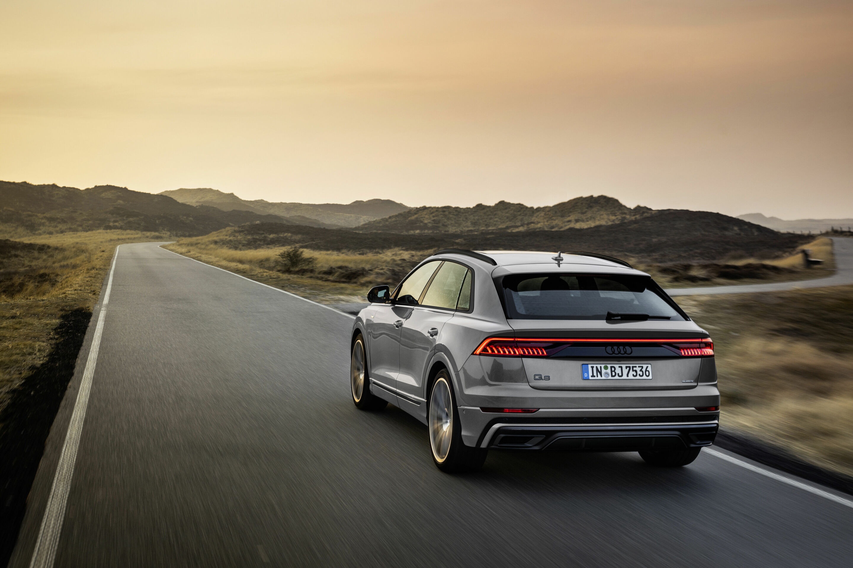 Audi SQ8 V8 rear driving at sunset