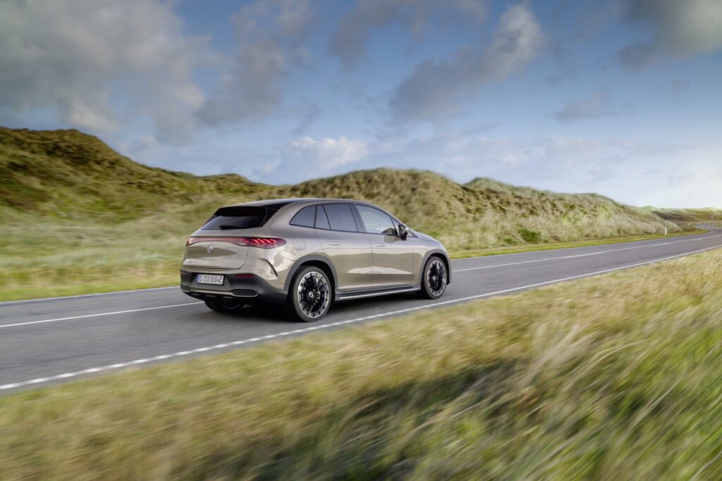 Mercedes EQE SUV rear three-quarter driving shot showing the sloping roofline