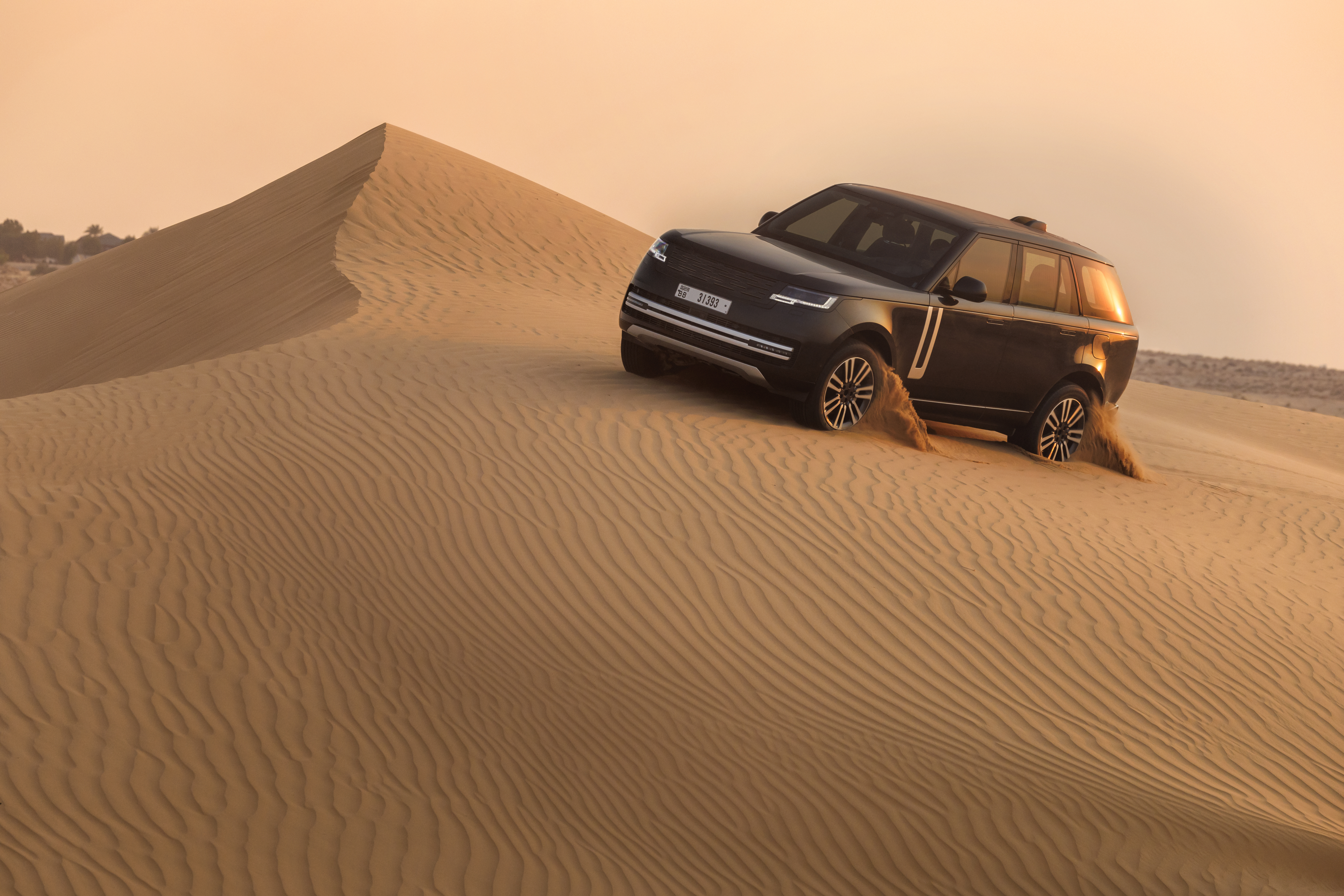 Range Rover Electric prototype side profile, desert hot-weather testing 2024