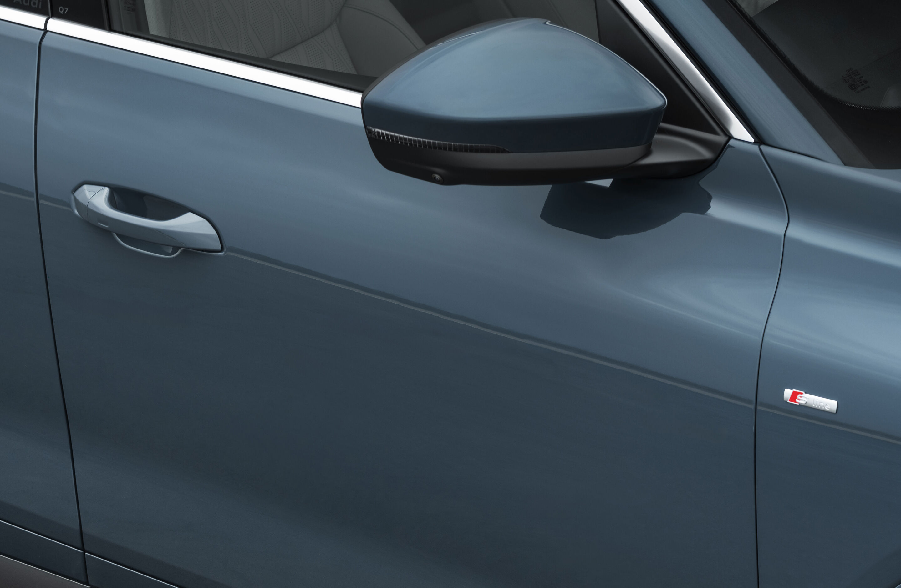 Audi door and badge detail, illustrative of a premium car bought on PCP or HP finance and the FCA motor finance redress window