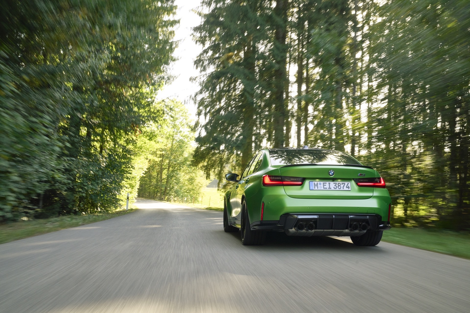 BMW M3 G80 used rear three quarter on a tree lined road
