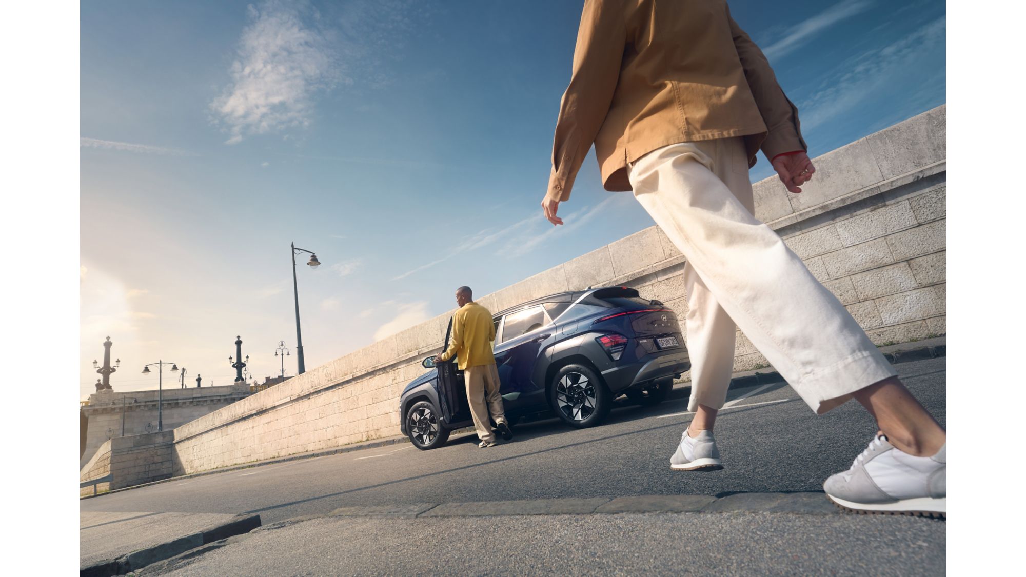Hyundai Kona Hybrid lifestyle shot on a bridge, cheap to run family crossover