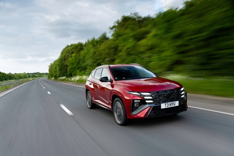 Hyundai Tucson Motability family SUV, red N Line on a UK road