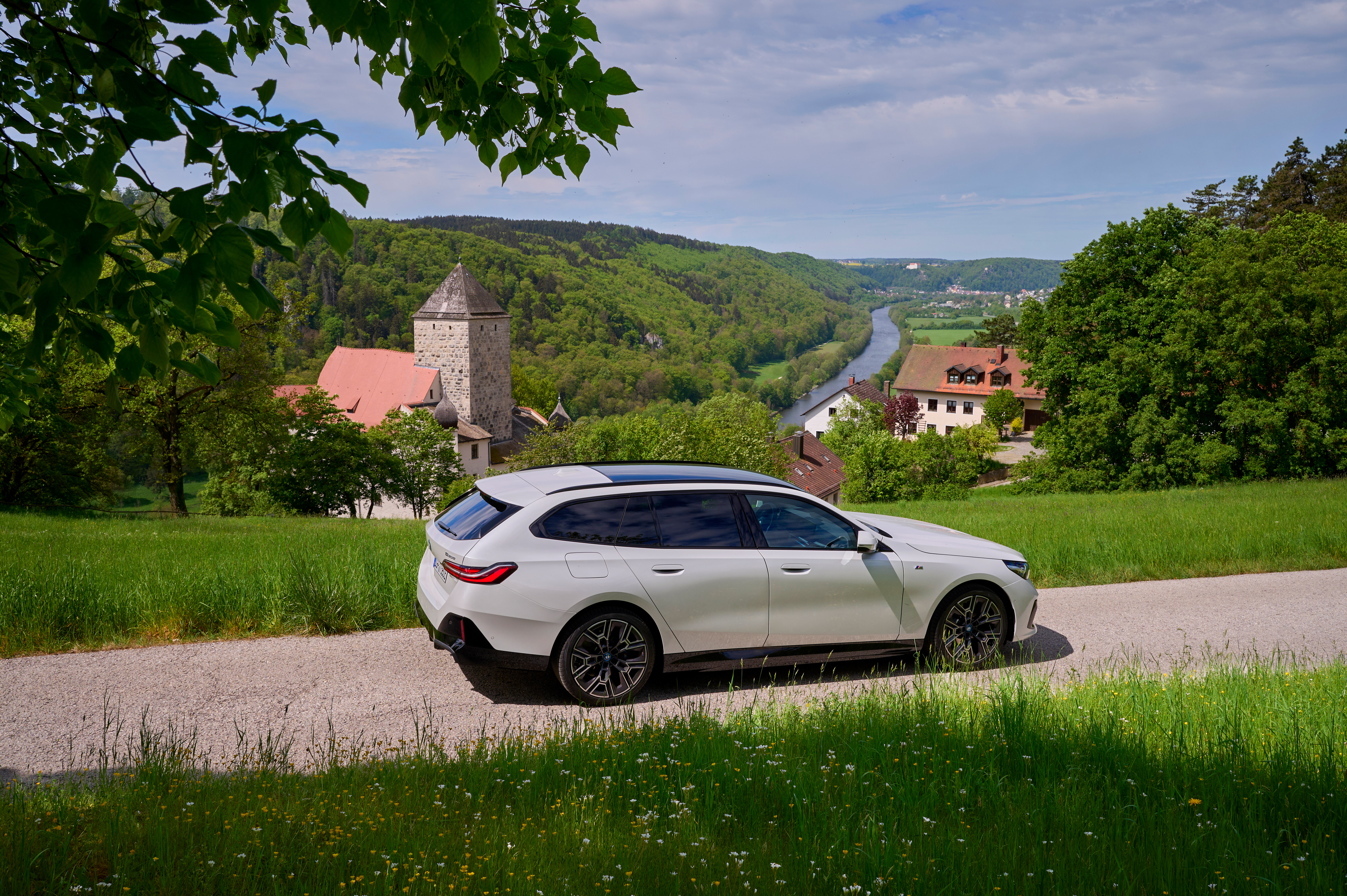 BMW 5 Series G61 Touring 530e in a scenic valley, Saloon or Touring verdict