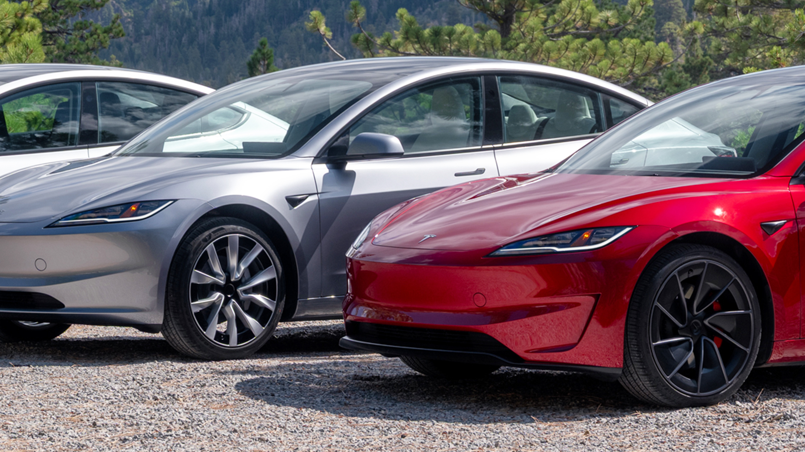 Tesla electric cars lined up, illustrating EV salary sacrifice fleets and early-exit terms