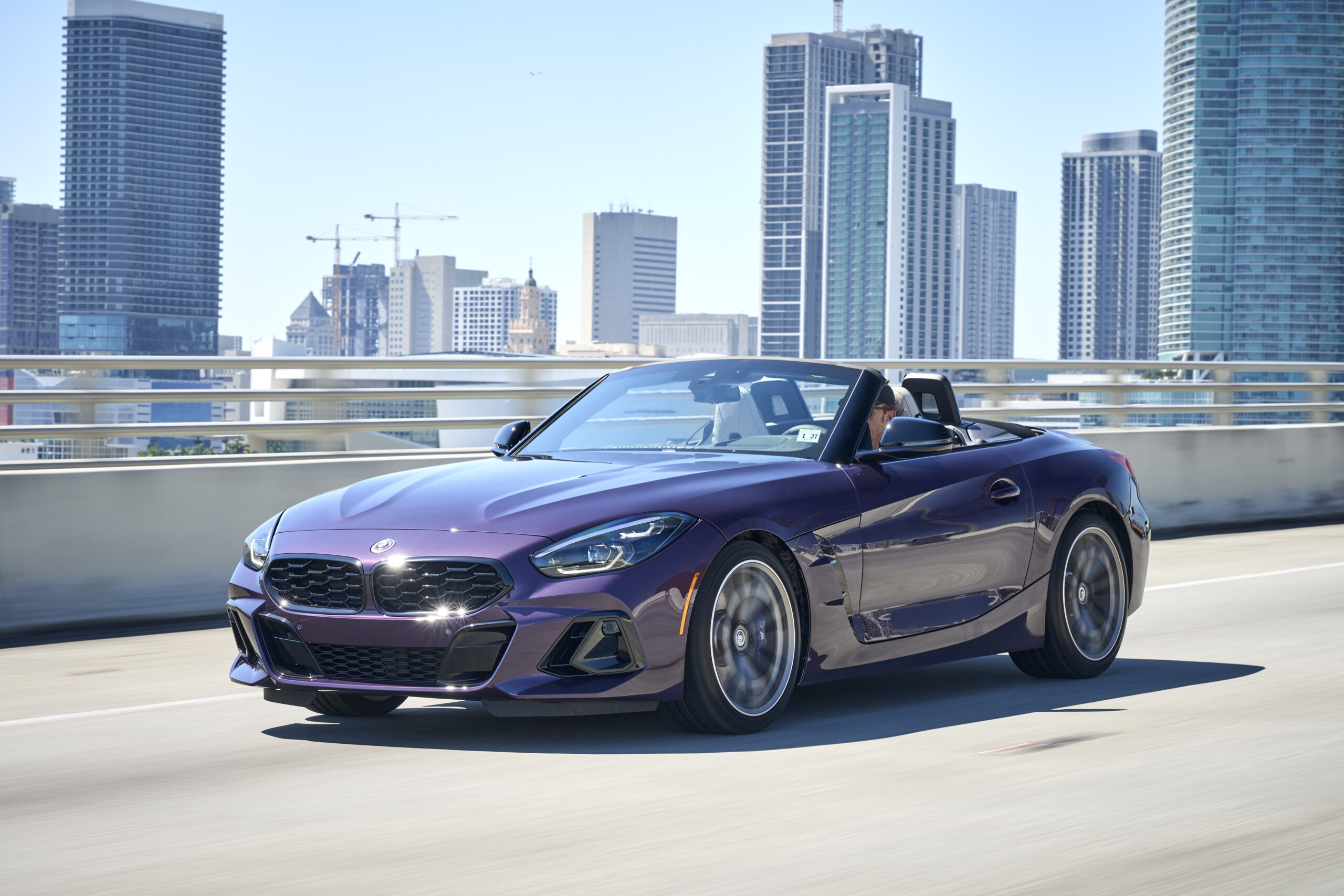 BMW Z4 G29 used roadster in Thundernight purple driving on a city road