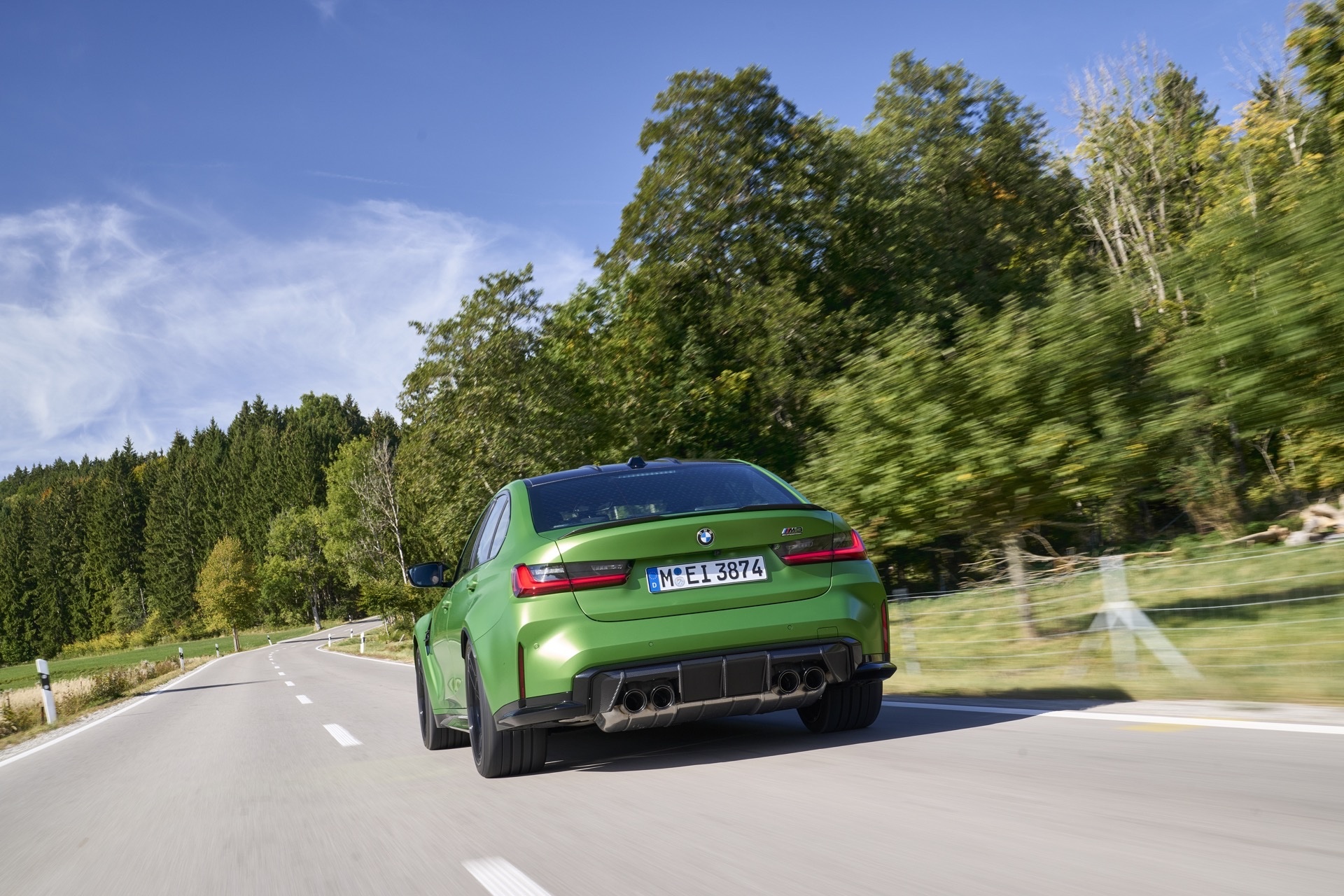 BMW M3 G80 used rear view with quad exhaust on open road