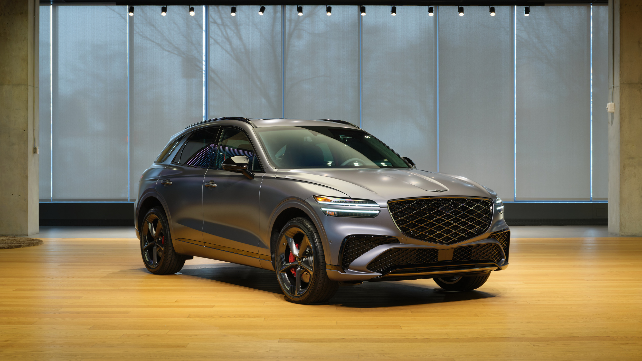 Genesis GV70 used front three-quarter studio shot showing the crest grille and matrix lights
