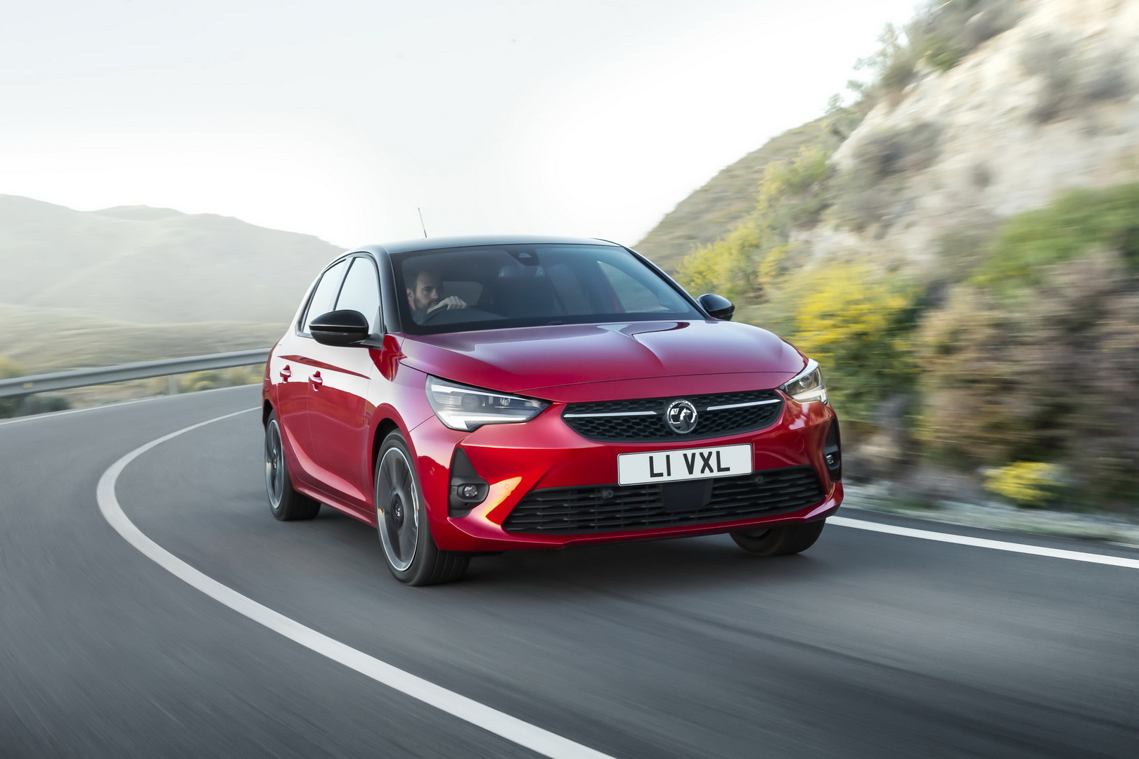 Vauxhall Corsa Electric finance offer car cornering on a mountain road