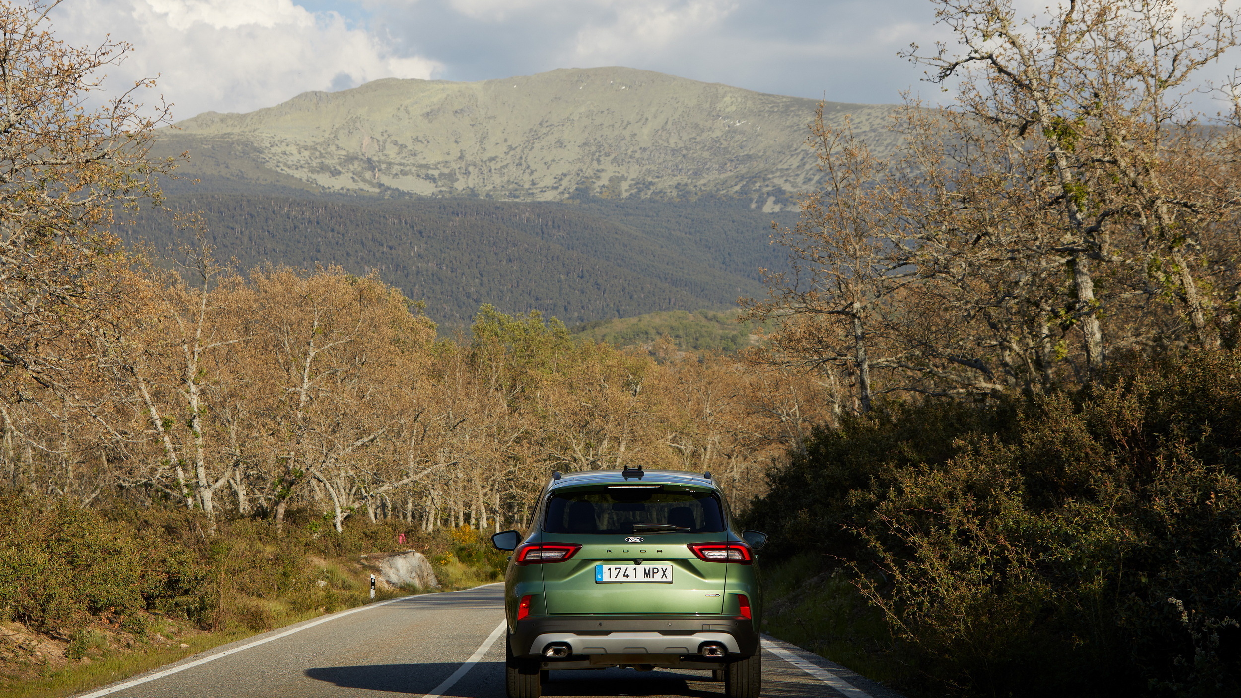 Ford Kuga PHEV rear view on a mountain road