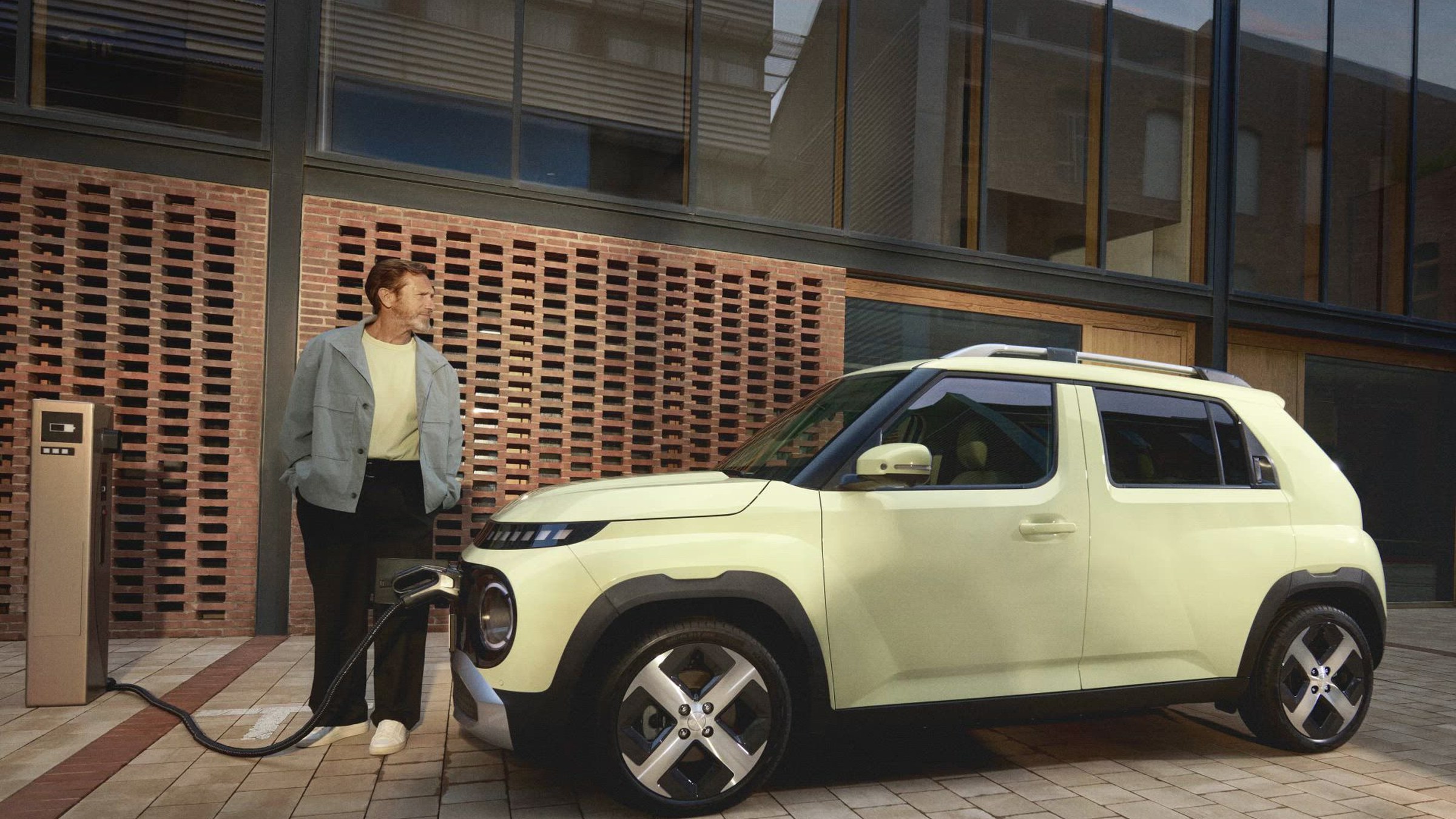 Hyundai Inster charging at a kerbside public charger, official Hyundai image