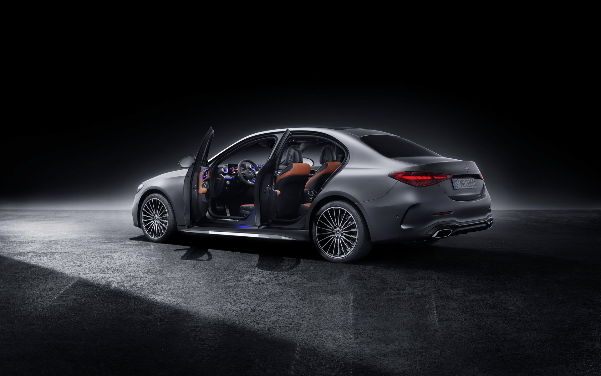 Mercedes C-Class W206 saloon rear three-quarter with the doors open showing the cabin