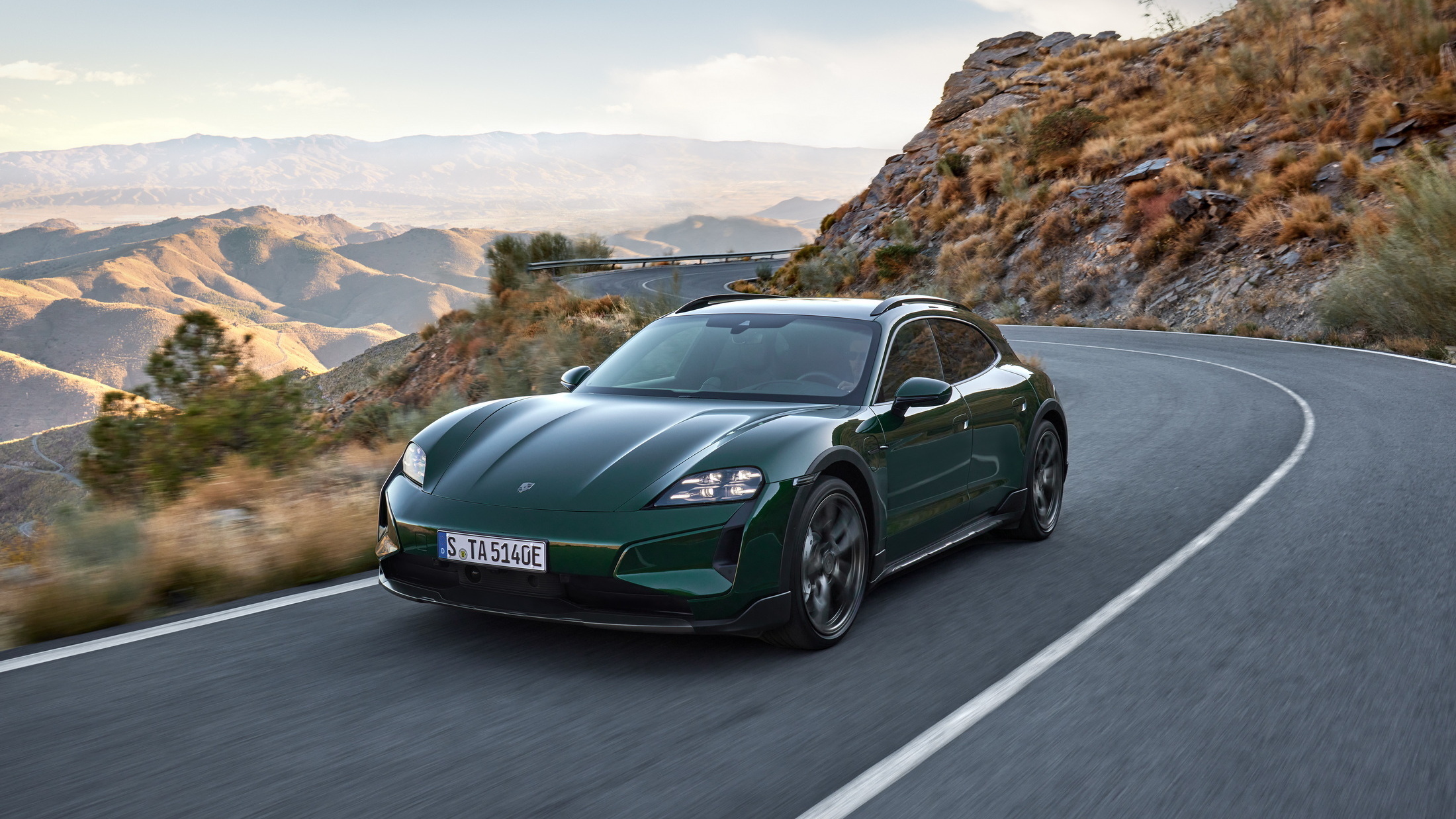 Used Porsche Taycan Cross Turismo driving on a mountain road