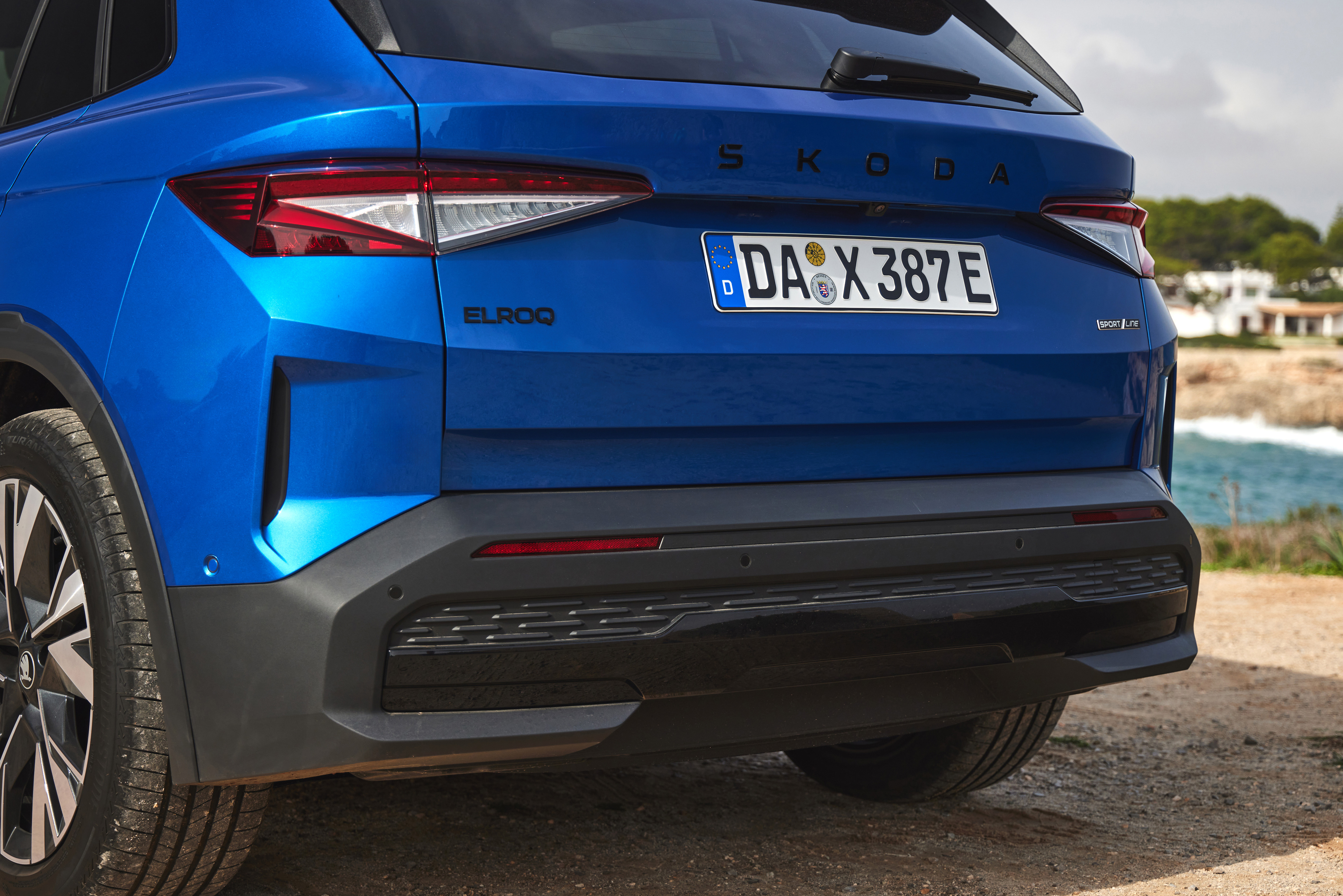 Skoda Elroq SportLine rear three-quarter in a scenic setting