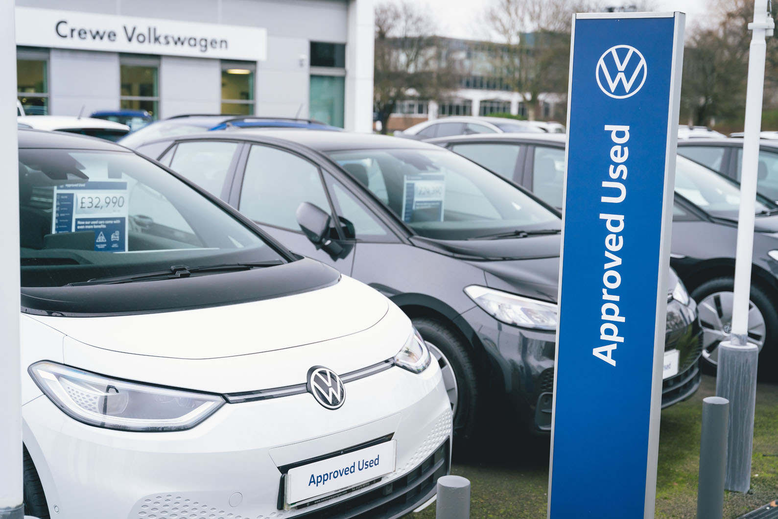 Three-year-old used family EVs lined up on a UK forecourt