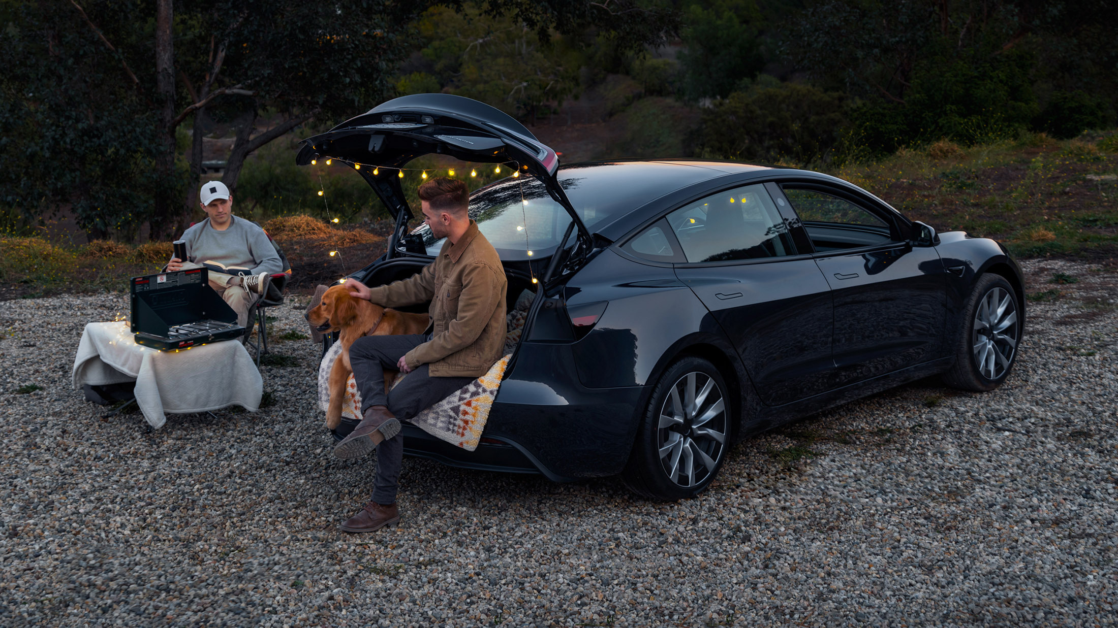 Tesla Model 3 with the boot open on a trip, a salary-sacrifice company-car EV for UK drivers