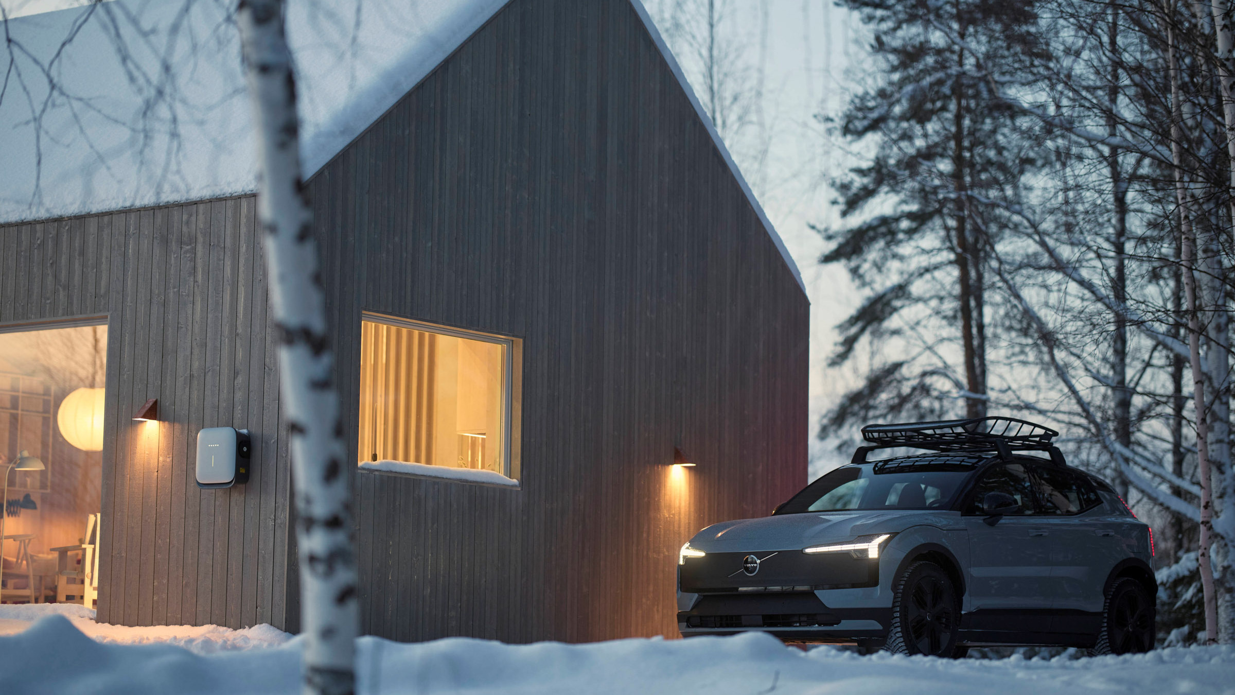 Volvo EX30 grey parked in snow, rear three-quarter